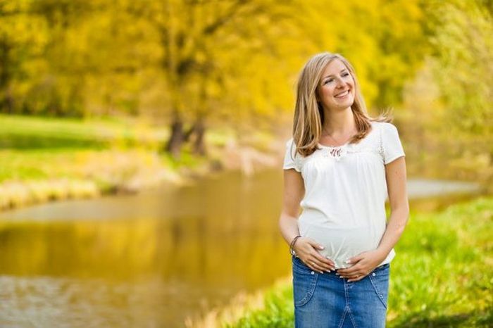 Беременная женщина гуляет на природе
